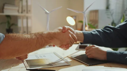 Green Energy Engineers Shaking Hands and Discussing Project in Office Stock Footage 265937485