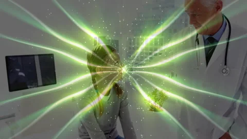 Green energy pattern appearing between child patient and doctor, intensifying Stock Footage 310151412
