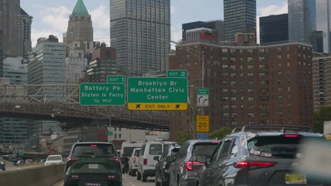 Green Exit Signs, Queuing Traffic, Skyline Towers, Brick Housing Stock Footage 343407560