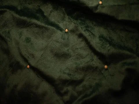 A green fabric with a pattern of small dots Stock Photos
