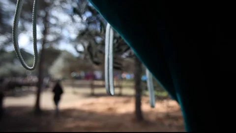 Green fabric tent door in camp in the forest with focus change handheld Stock Footage