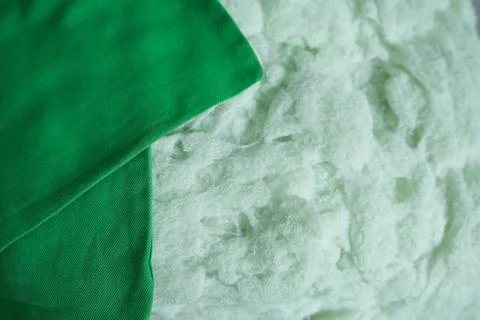 Green fabric texture background. Artificial filling for cushions. Foto stock