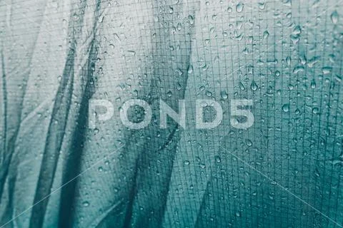 Green fabric with water drops as background. Water drops on tent awning. Prot Stock Photos