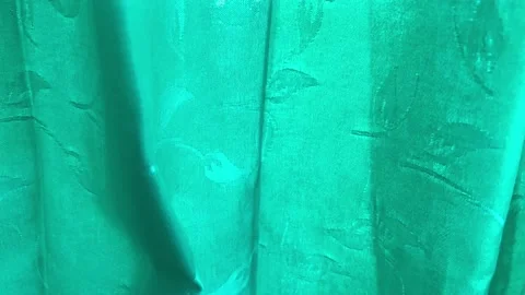 Green fabric winding in the wind. Emerald green curtain with floral pattern as a Stock Footage 167601775