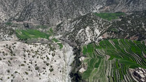 Green Farms and Rustic Mud Dwellings in the Mountains Stock-Footage 274473611
