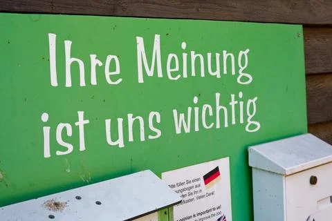 Green feedback sign and mailboxes on wooden building Stock Photos