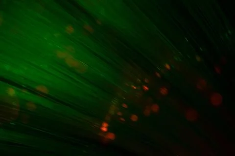 Green Fiber Optic Light Rays with Glowing Particles Foto stock