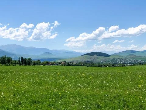 Green field and blue sky, mountain landscape with blue sky and clouds Stock Photos