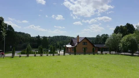 A green field full of daisies, a view at the cottage village areas Stock Footage 148734142