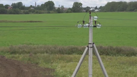Green field, lighting pole, electricity pole Stock Footage 294180198