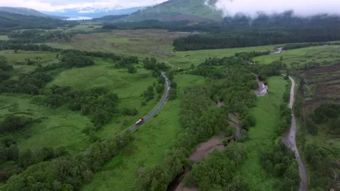 A green field with a river running through it Stock Footage 306492434