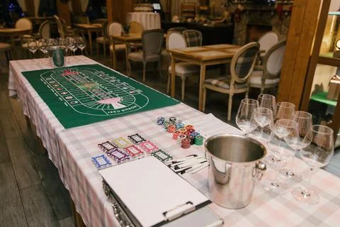 A green field with a stack of chips and cards for playing in a wine casino Stock Photos