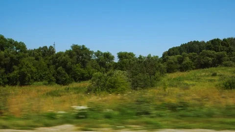 Green Fields Against Hills With Trees From A Moving Car Windshield Stock Footage 112275048