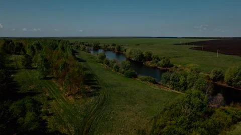 Green fields and river under blue sky near Elista, Kalmykia, with Buddhist Stock Photos