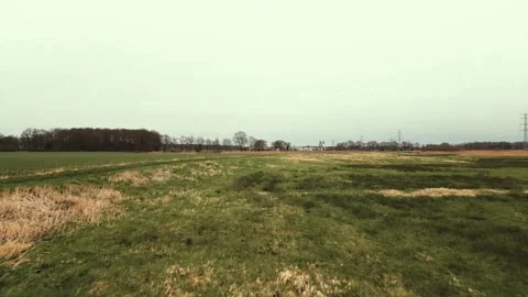 Green fields and a stream flowing through the countryside Stock-Footage 293943359