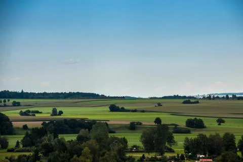 Green fields, green meadows, dark forests and the blue sky Фото