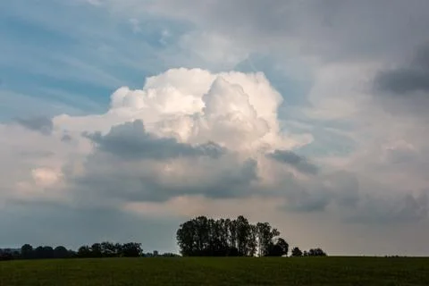 Green fields, green meadows, forests and a dramatic sky Stock-Fotos