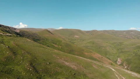 Green fields, meadows aerial: road cars driving on background. hills, farmlands Stock Footage 201306924
