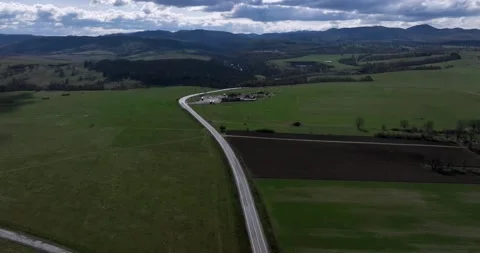 Green fields, meadows aerial: road cars driving in the background Stock Footage 201489549