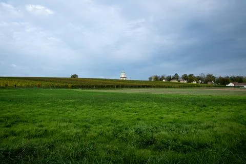 Green fields meet a distant white dome Stock Photos