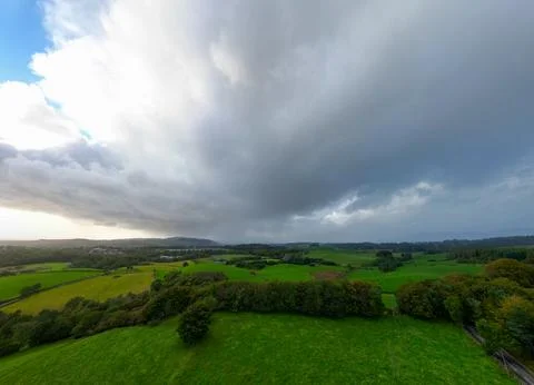 Green fields moody sky with trees and pastures Stock-Fotos