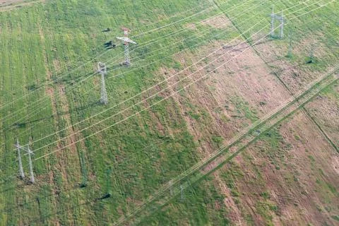 Green fields with a power line. Stock Photos
