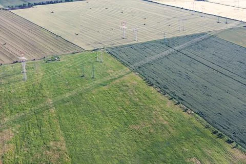 Green fields with a power line. Stock Photos