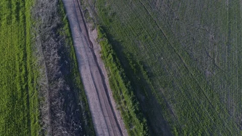 Green fields with a van driving a muddy road 库存影片 126147593