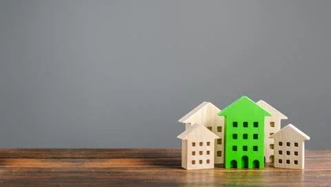 Green figure of a residential building stands out among the rest of the hou.. Stock Photos