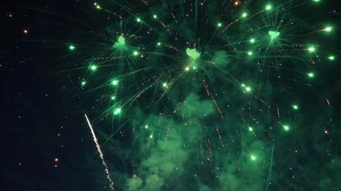Green fireworks exploding in the night sky Stock Photos