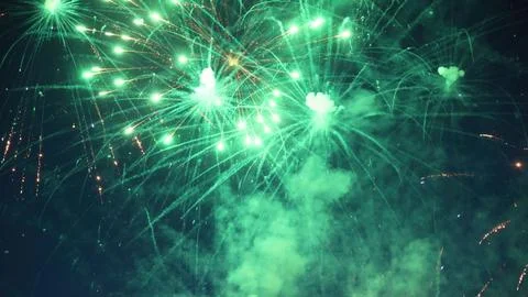 Green fireworks exploding in the night sky during a celebration Stock Photos