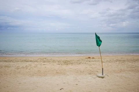 Green flag on the beach Stock Photos