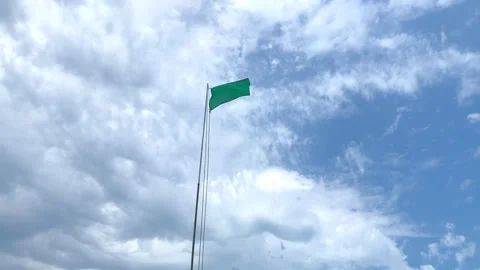 Green flag in the blue sky at Hendaye beach in France Stock Footage 345145798