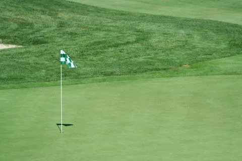 Green flag on a golf green Stock Photos
