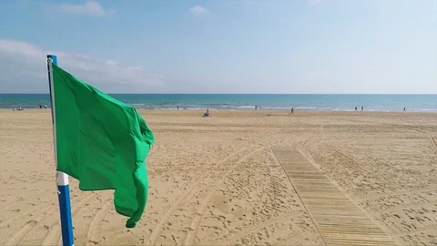 Green flag on the Mediterranean beach Видео 93830192