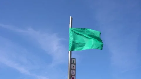 Green flag on spain beach closeup. Permission to swim in the sea. Calm water Stock Footage 241397888