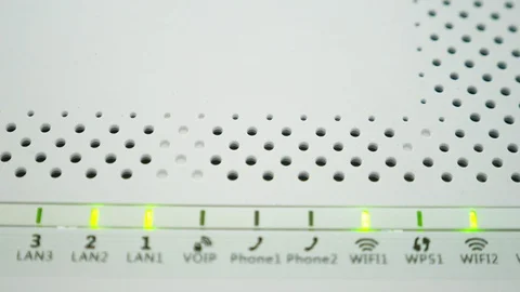 Green flashing lights on a white modem. Wireless router server LED light, close Stock Footage 99529952