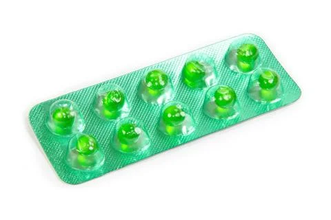 Green flatulence pill in the blister pack Stock Photos