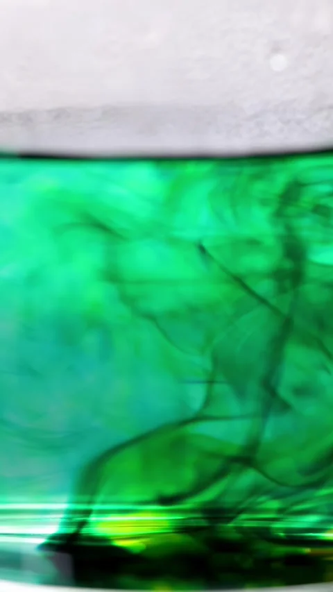 Green Food Coloring Diffusing in Hot Water Close-Up Video stock 318997957
