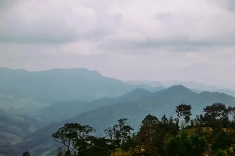 Green forest and mountain range at dawn. Nan province, Thailand. Stock Photos