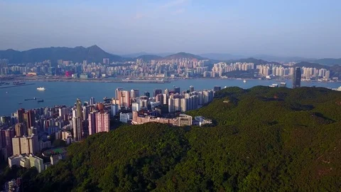 Green forested Braemar Hill and urban North Point aerial view at evening Stock Footage
