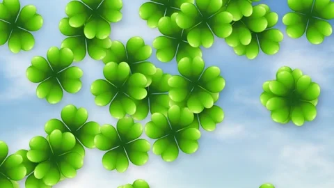 Green Four Leaf Clovers Falling Against a Bright Cloudy Blue Sky Stock Footage 339043447