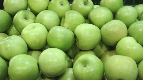 Green fresh appetizing apples lie on the counter Stock Footage 218378355