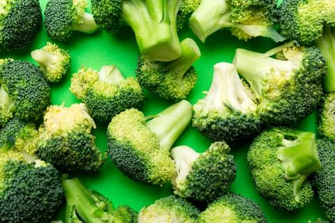 Green fresh broccoli background close up on colored table. Vegetables for d.. Stock Photos