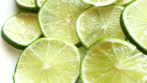 Green fresh rotating lime slices turning round Stock Footage 133559801