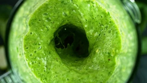 Green fresh smoothie blended in blender, top view Stock Footage 130312888