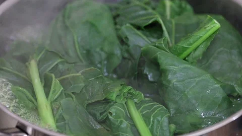 Green fresh vegetables boiling in water in iron pot Stock Footage 104194334