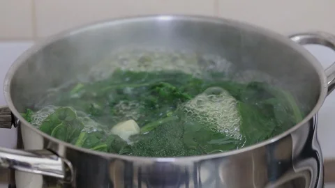 Green fresh vegetables boiling in water in iron pot Stock Footage 104195675