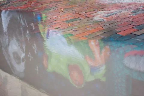 Green frog mural reflection 写真素材