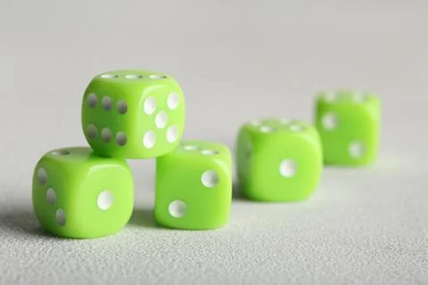 Green game dices on light background, closeup Stock Photos